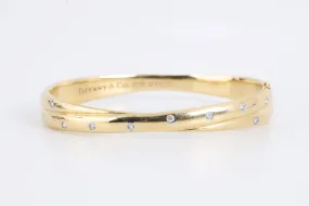 7" Tiffany & Co. 18k Gold Diamond Etoile Crossover Bangle Bracelet (44.12g.)